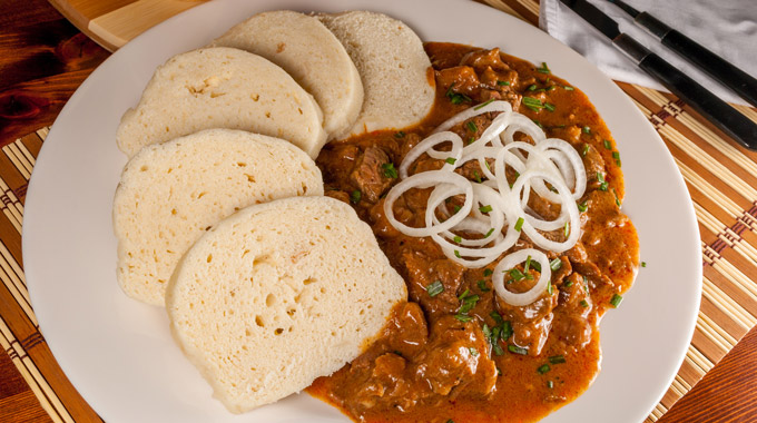 A plate of goulash and bread dumplings